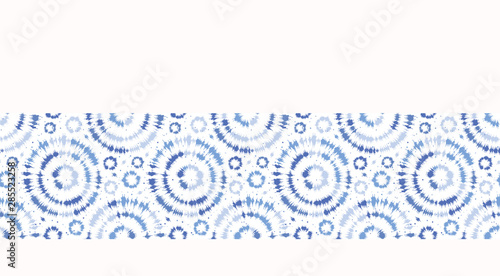 Indigo blue  border shibori tie dye sunburst circle background. Seamless pattern on white background. Japanese style batik textile. Variegated for summer fashion edging trim.