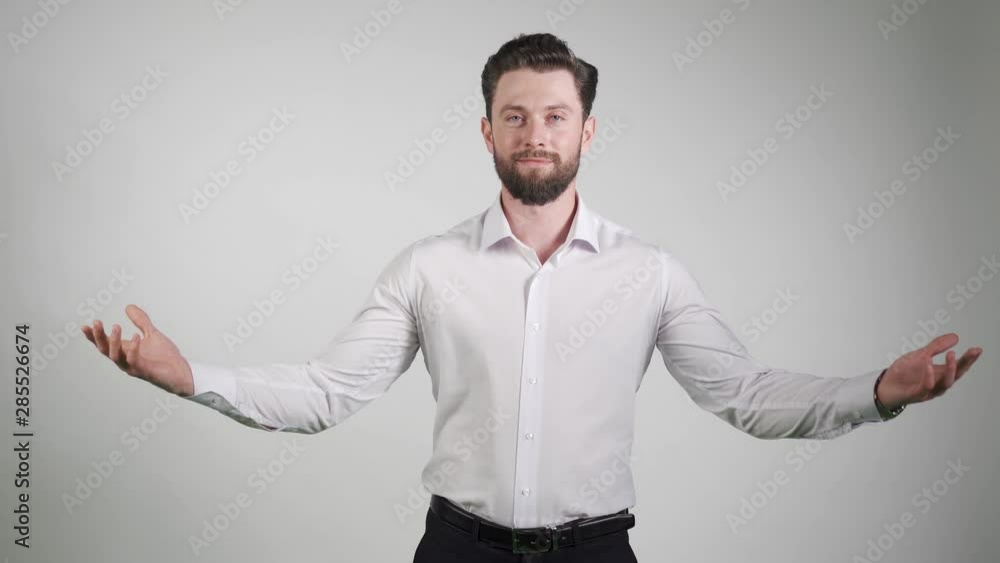 Young happy bearded man gesturing with hands and showing balance. What to choose. Young happy bearded man gesturing with hands and showing balance. What to choose.