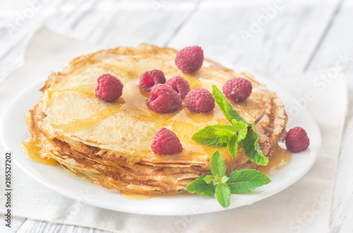 Stack of crepes with raspberries