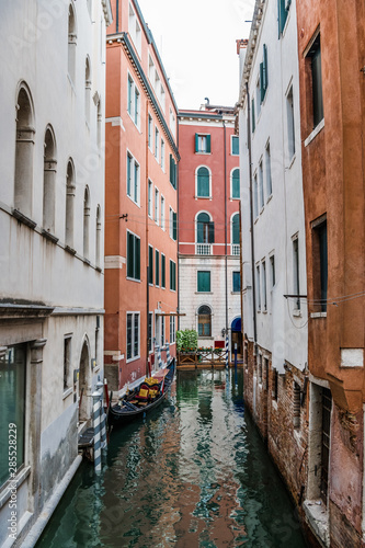 Narrow Venetian canal between two houses © andrey_iv