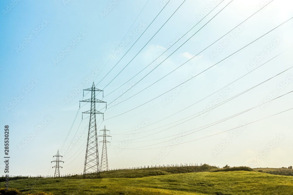 electricity pylons ,on background of blue sky electricity pylons ,on background of blue sky