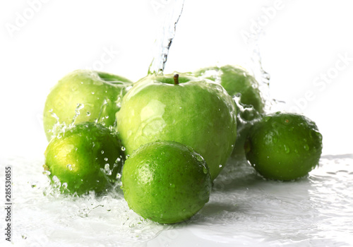 Ripe fruits with water splash on white background