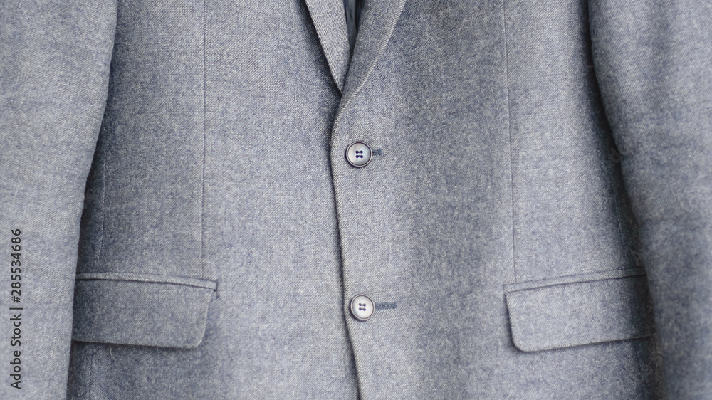 Close-up of a button on a blue business jacket Close-up of a button on a blue business jacket