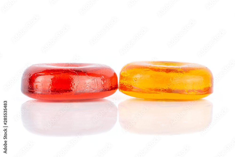 Group of two whole orange and cherry colourful hard candy isolated on white background Group of two whole orange and cherry colourful hard candy isolated on white background