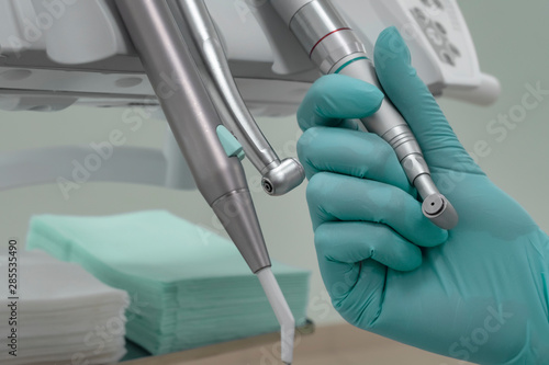 Close-up, dentist's hand takes dental tool. The health care structure in the foreground.