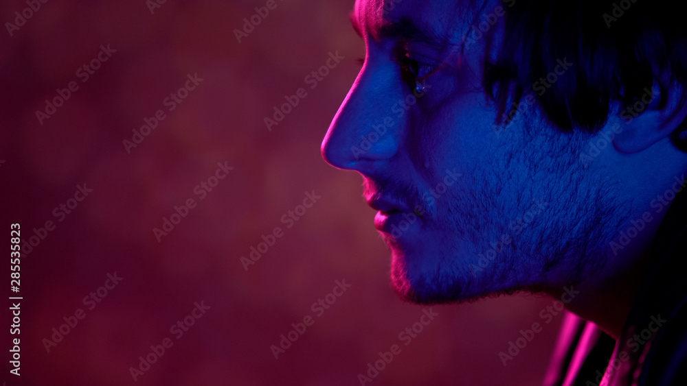 Depressed guy crying in plane, leaving native country, migrant feeling homesick Depressed guy crying in plane, leaving native country, migrant feeling homesick