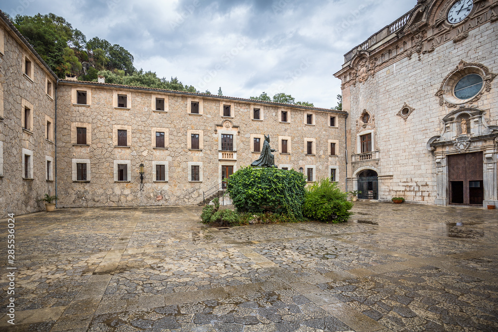 Memorial to bishop Pere-Joan Campins in cloistered courtyard of Santuario de lluc Monastery
