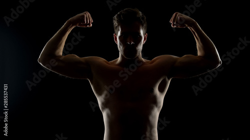 Strong masculine man showing biceps muscles, bodybuilding challenge, sports