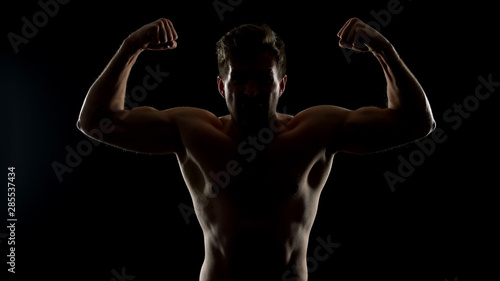 Furious man showing biceps muscles, demonstrating power, ready for illegal fight