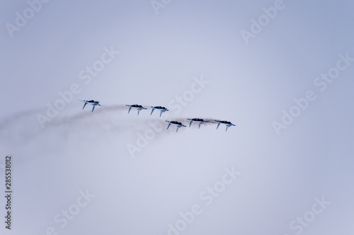 Air show in the sky above the Krasnodar airport flight school. Airshow in honor of Defender of the Fatherland. MiG-29 in the sky.