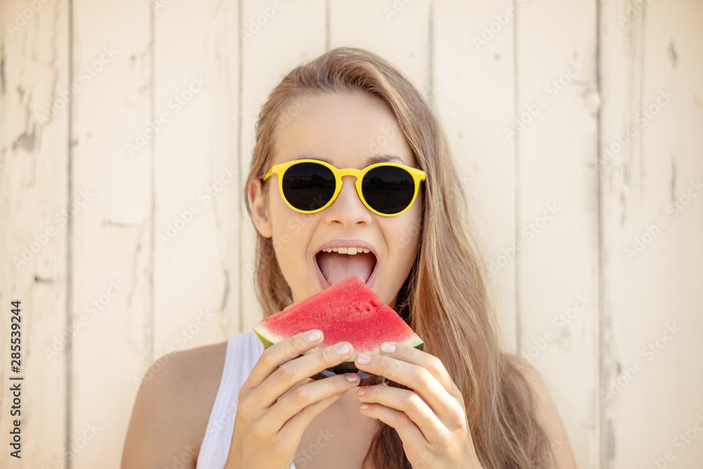 © PhotoGranary - Summertime in garden. Young beautiful and smiling woman in garden with juicy watermelon. © PhotoGranary - Summertime in garden. Young beautiful and smiling woman in garden with juicy watermelon.