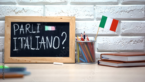 Do you speak Italian written on board, international flag in box, language photo
