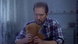Desperate male holding teddy bear, suffering pain of child loss terrible tragedy
