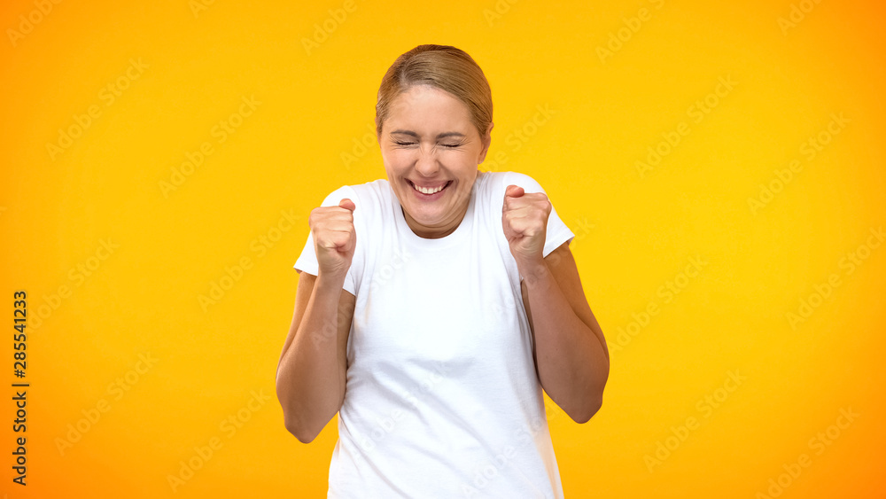 Excited woman rejoicing good news on bright background, amazement, success Excited woman rejoicing good news on bright background, amazement, success