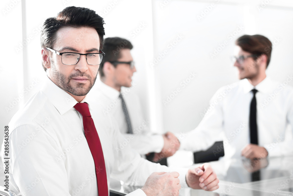 successful businessman on blurred office background successful businessman on blurred office background
