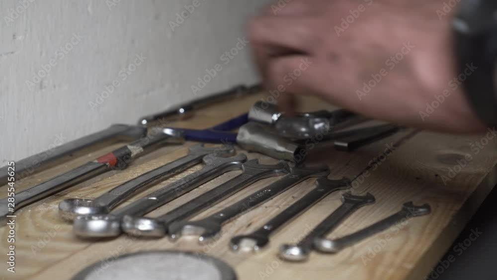 Close up of mechanic hands, putting tools in order Close up of mechanic hands, putting tools in order