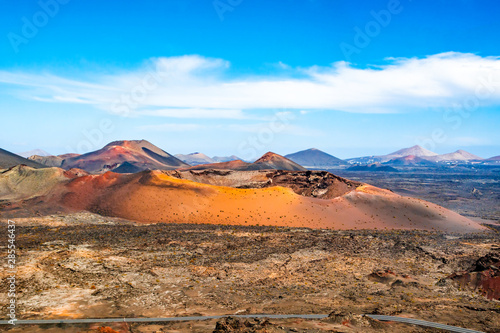 Amazing panoramic landscape of volcano craters in Timanfaya national park. Popular touristic attraction in Lanzarote island, Canary islans, Spain. Artistic picture. Beauty world.