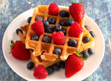 Two Classic Berry Waffles on a Rustic Blue Wood Table