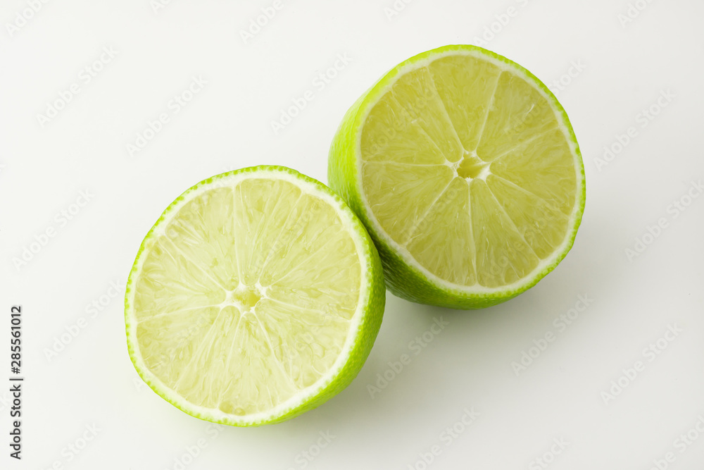 Green lime cut on a white background, for design, horizontal photo Green lime cut on a white background, for design, horizontal photo