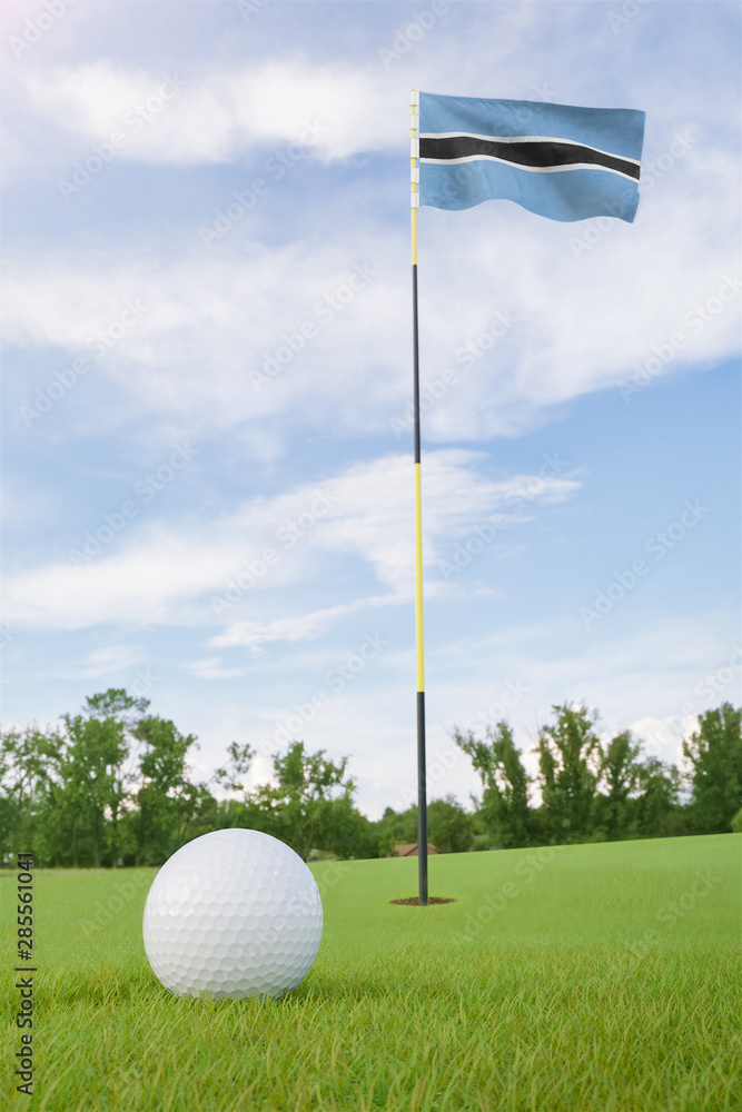 Obraz premium Botswana flag on golf course putting green with a ball near the hole