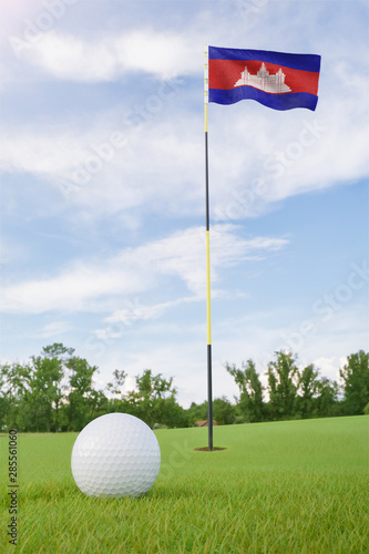 Cambodia flag on golf course putting green with a ball near the hole