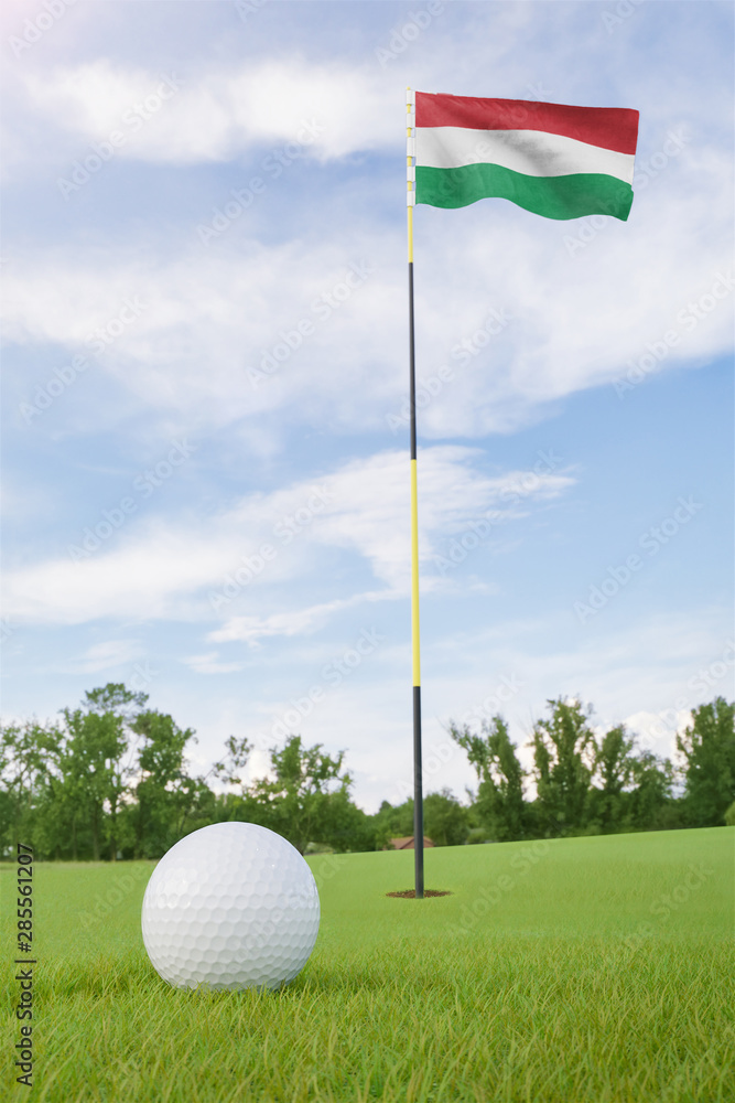 Obraz premium Hungary flag on golf course putting green with a ball near the hole