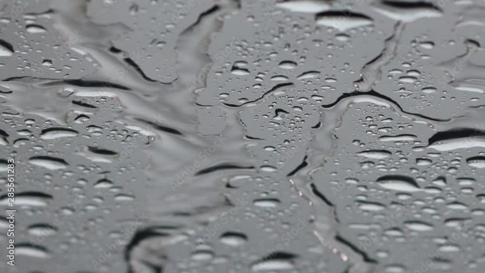 Blurred water drops in front of the mirror