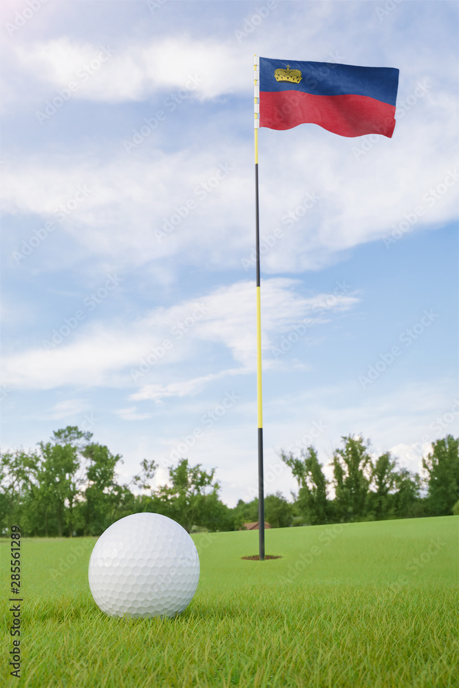 Obraz premium Liechtenstein flag on golf course putting green with a ball near the hole