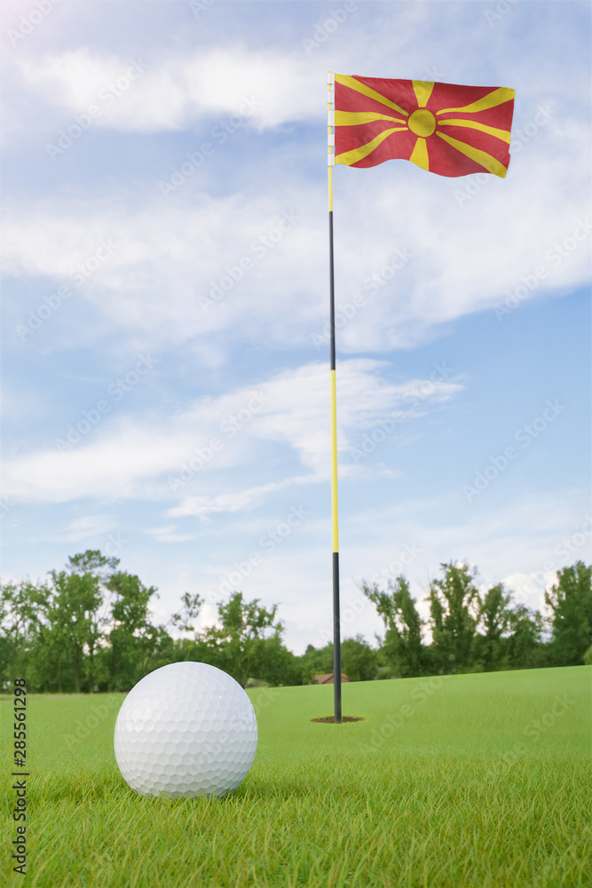 Obraz premium Macedonia flag on golf course putting green with a ball near the hole