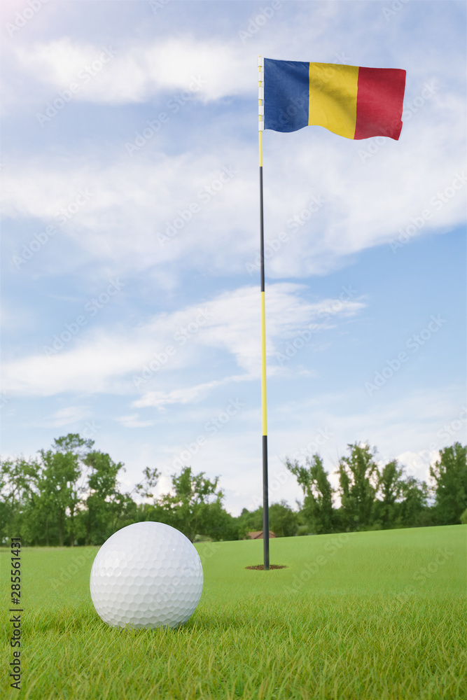 Obraz premium Romania flag on golf course putting green with a ball near the hole