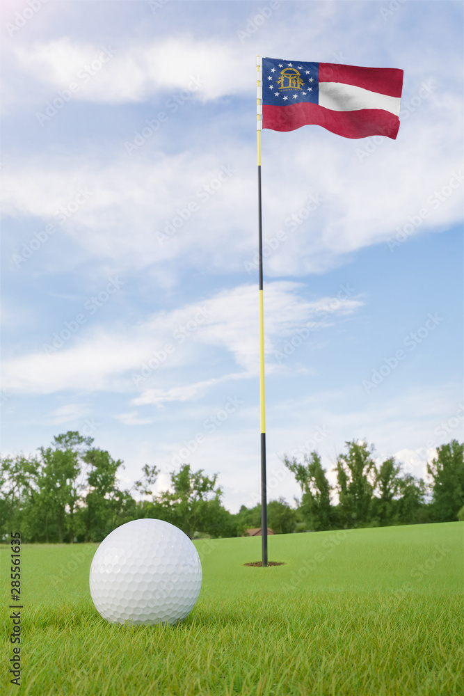 Obraz premium Georgia flag on golf course putting green with a ball near the hole