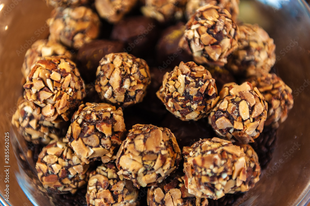 A bowl of round nut covered candies. A bowl of round nut covered candies.