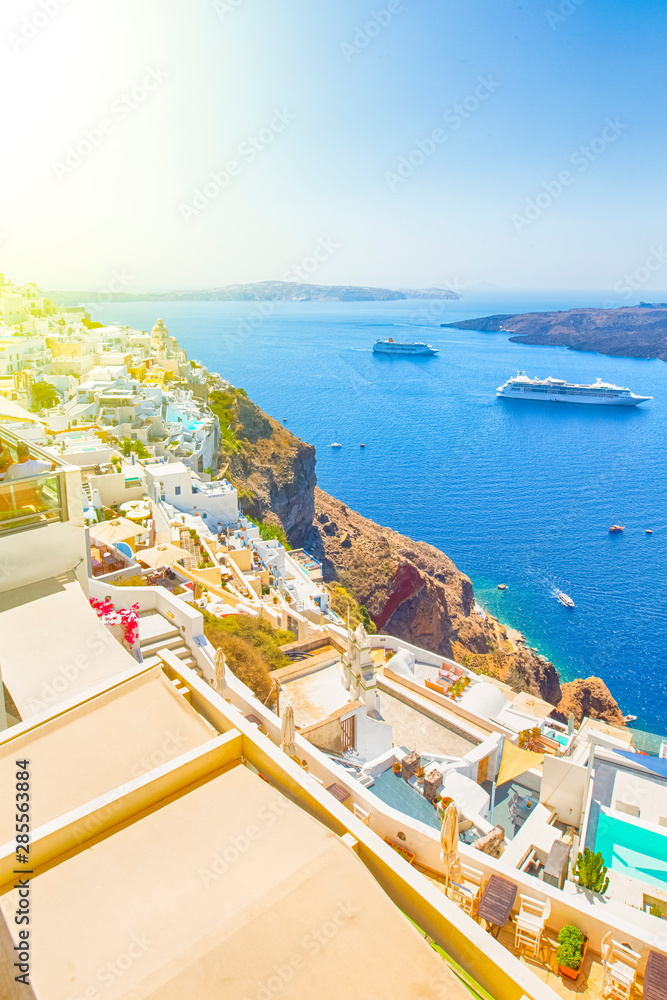 Panorama of Thira on Santorini Island with Line of Cruize Ships on Background.
