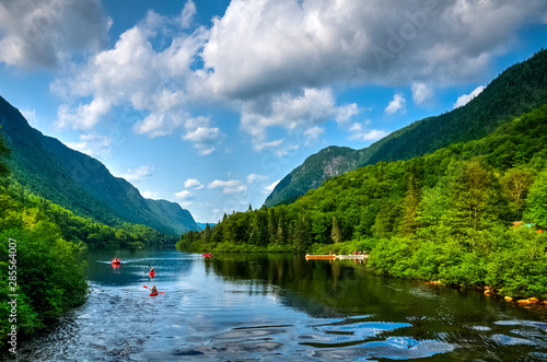 Adventurous people rafting Jacques Cartier river on a perfect sunny summer day, Quebec, Canada photo