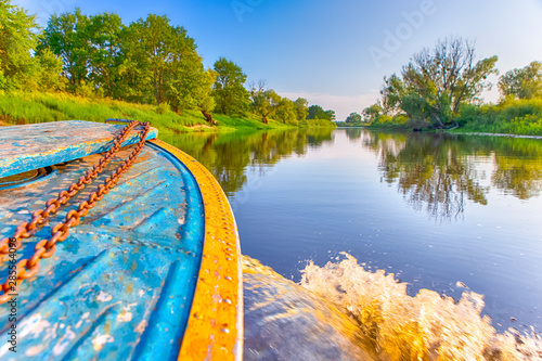 Closeup of Boat Fore Traveling Through the River with Water splashes From Starboard Side photo