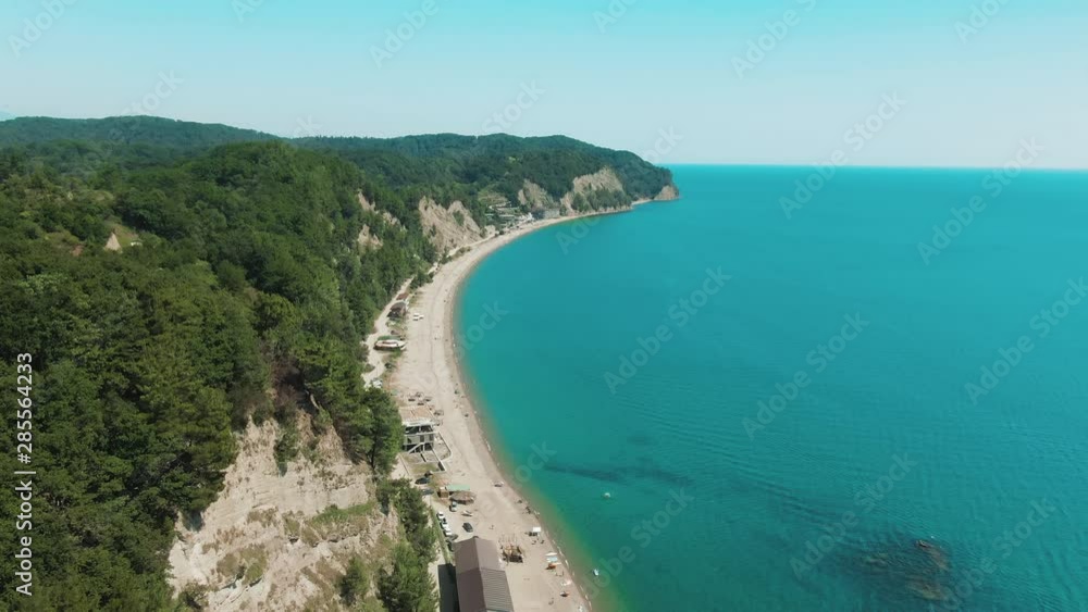 Aerial 4k view tropical beach with blue-green sea, green mountains of the rainforest. Secluded hidden beach in paradise. Blue sky, turquoise calm ocean waves of water. Aerial 4k view tropical beach with blue-green sea, green mountains of the rainforest. Secluded hidden beach in paradise. Blue sky, turquoise calm ocean waves of water.