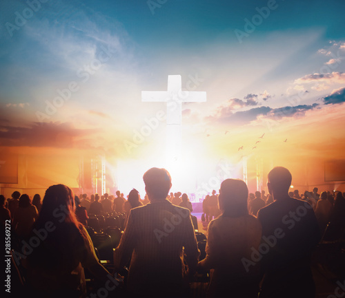 Fényképezés Worship concept: Group of people holding hands praying worship at sunset backgro