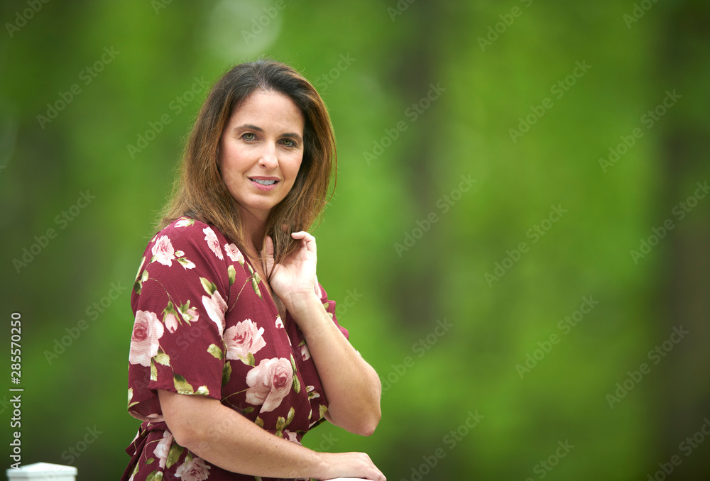 Beautiful Caucasian woman poses in sundress outside - shallow depth of field Beautiful Caucasian woman poses in sundress outside - shallow depth of field