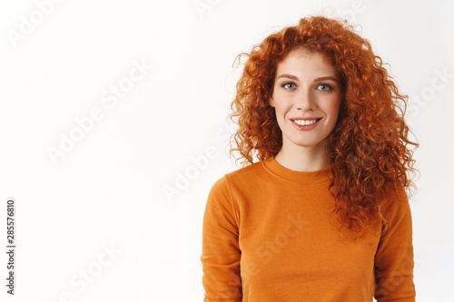 Konstfotografi Happy cute redhead woman with curly hair smiling sincere and carefree, standing