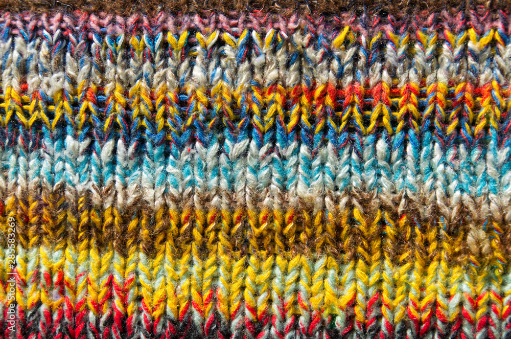 background of bright multi color striped fabric knitted by the hand background of bright multi color striped fabric knitted by the hand