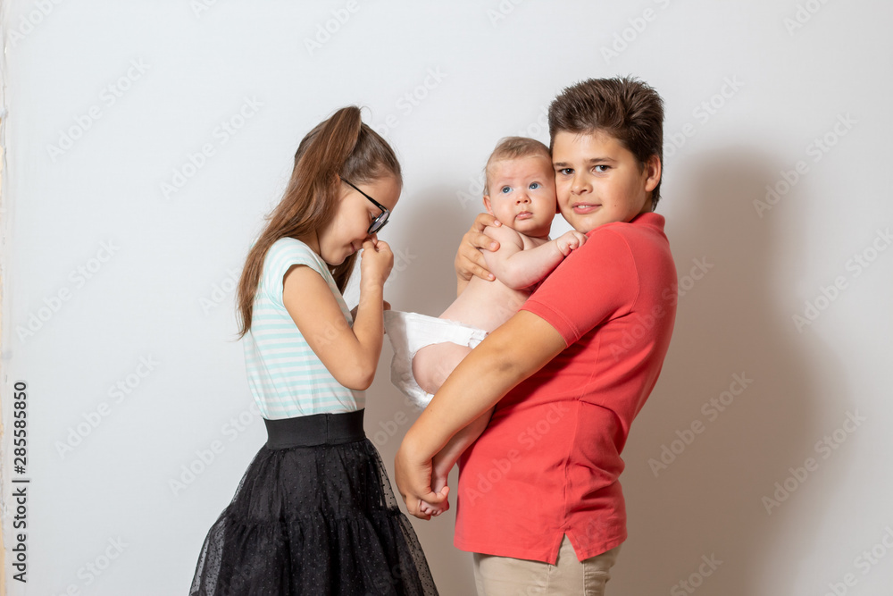 Children change the baby's diaper. Bad smell Children change the baby's diaper. Bad smell