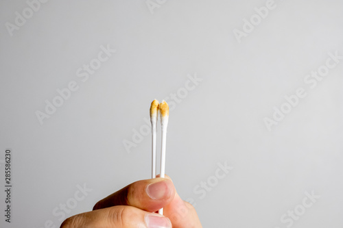 earwax on the wood spins the ears and earwax on the stick, both ears on the left side, right side photo