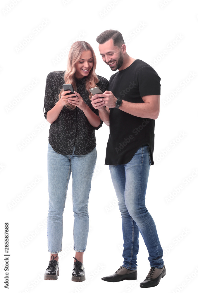 in full growth. stylish young couple with smartphones in full growth. stylish young couple with smartphones