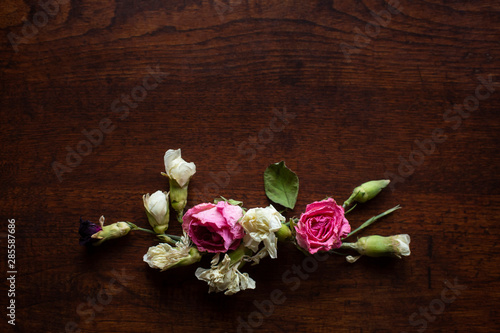 Flowers Composition on a wood table, Greeting card, Rose and carnation composition, Close up shot, Flat lay, top view, copy space.
