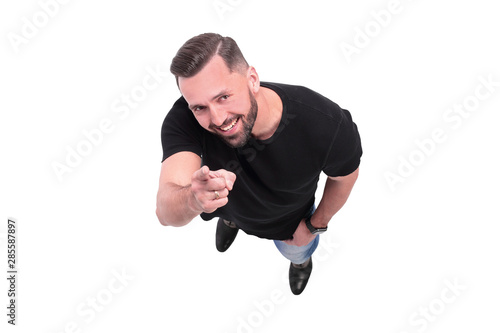 top view. smiling young man pointing at you photo