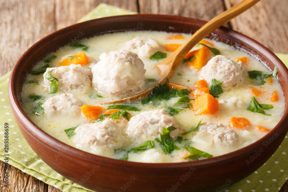Bulgarian chorba topcheta soup with meatballs, yogurt and vegetables close-up in a bowl. horizontal Bulgarian chorba topcheta soup with meatballs, yogurt and vegetables close-up in a bowl. horizontal
