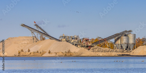 Sand mining at flooded borrow pit crop