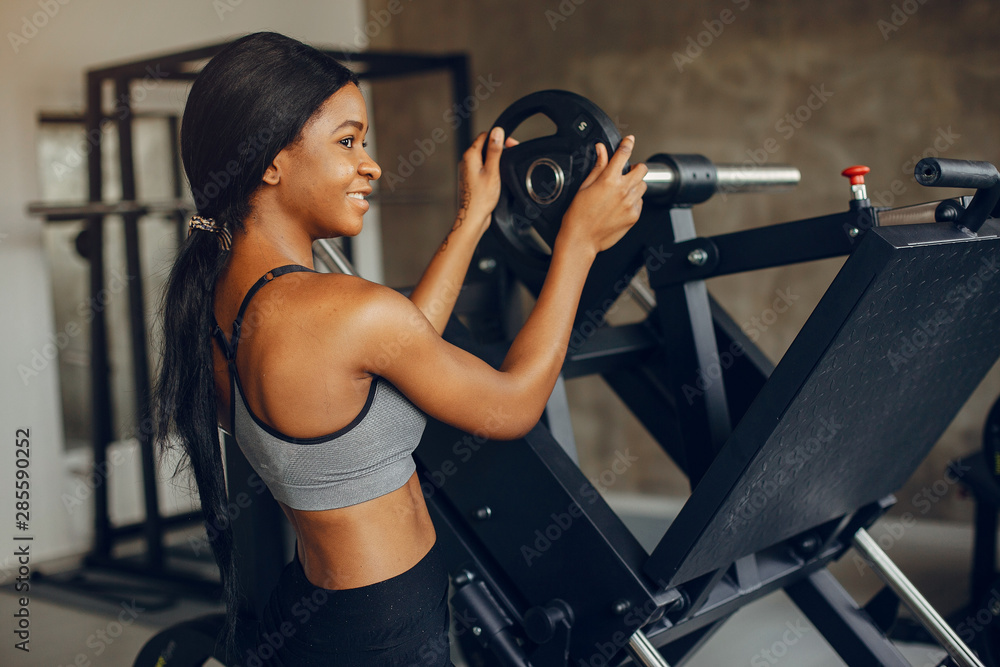 Beautiful black girl in the gym. A woman in a gray top