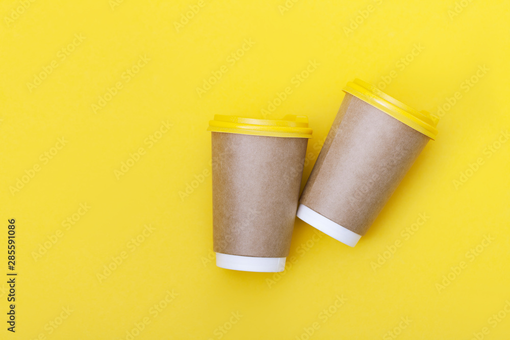 Morning coffee cup concept. Coffee to go on yellow background. Morning coffee cup concept. Coffee to go on yellow background.