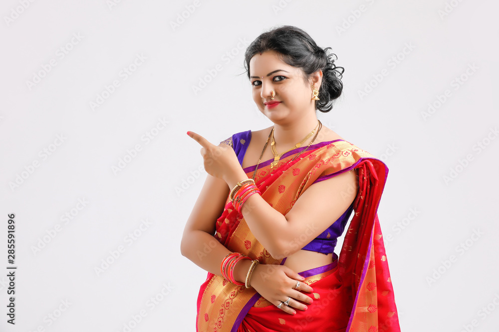 Happy Young woman wearing sari and showing direction with hand Happy Young woman wearing sari and showing direction with hand